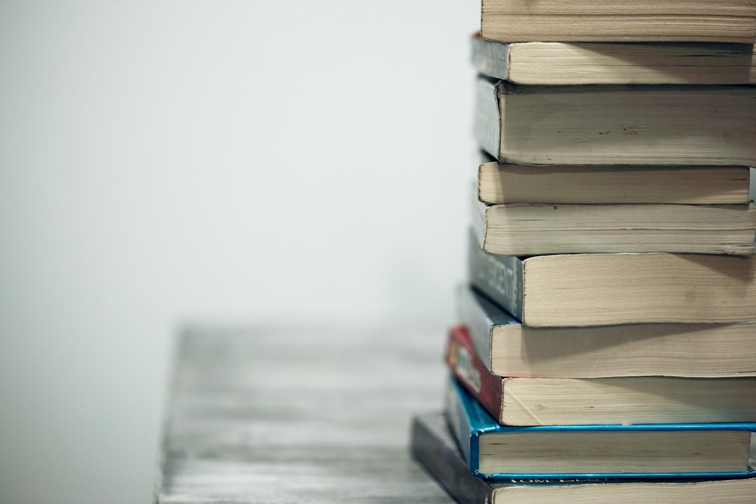 assorted-books-on-wooden-table-emp4sypj9x0